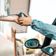 person at drive through handing credit card machine to customer